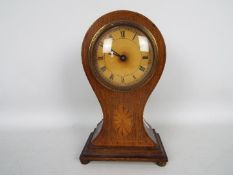 An Edwardian inlaid balloon cased mantel clock, Roman numerals to the dial, approximately 23 cm (h),