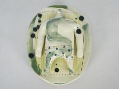 Jenny Southam - A studio pottery centrepiece in the form of a headless body sunbathing,