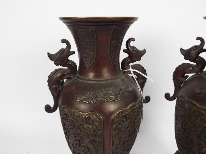 A pair of cast metal vases with twin chilong handles, cast decorative panels, - Image 2 of 5