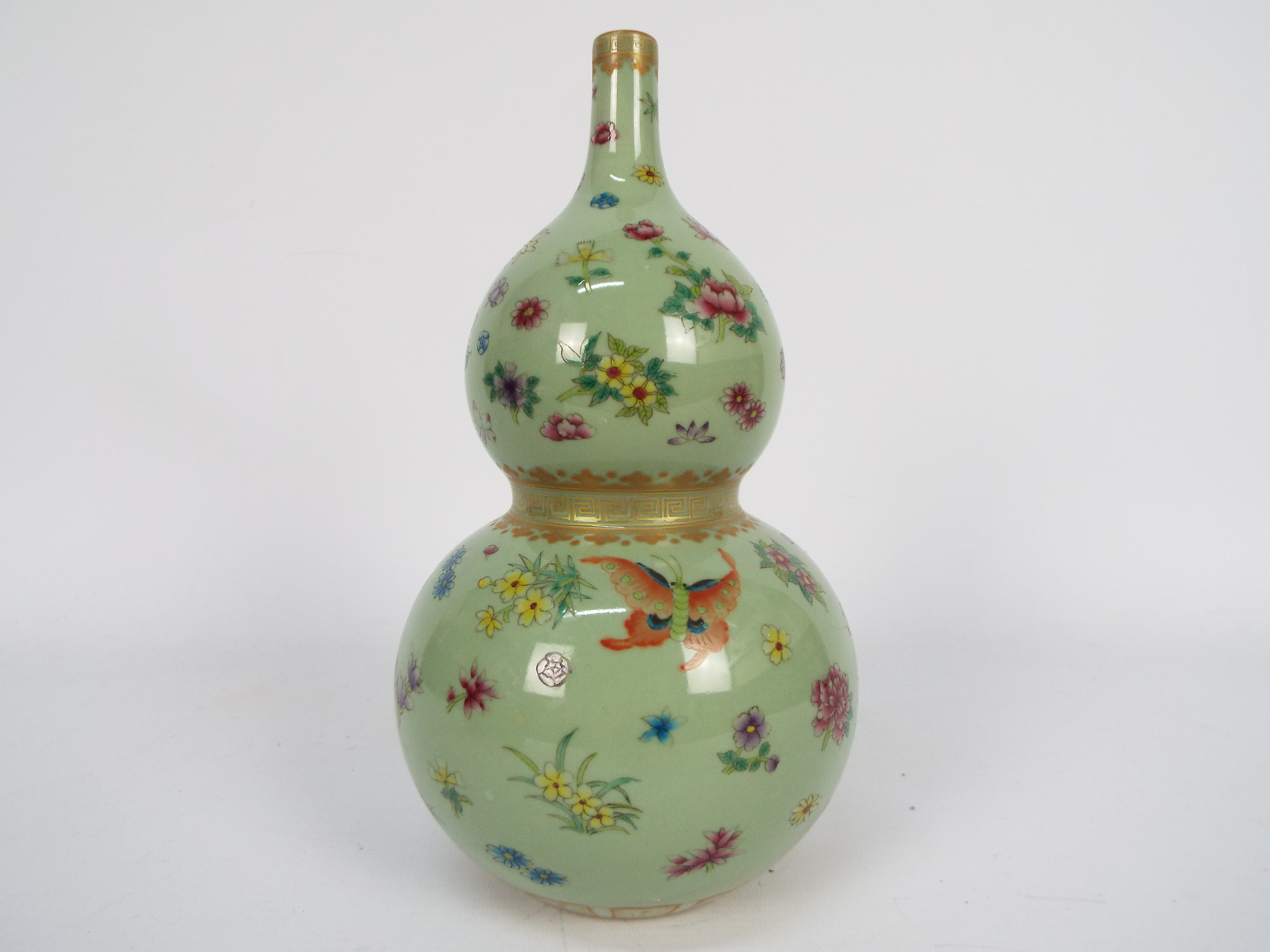 A Chinese double gourd vase decorated with flowers and butterflies against a green ground, - Image 12 of 18