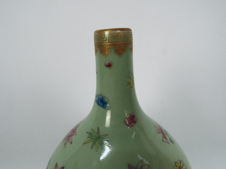 A Chinese double gourd vase decorated with flowers and butterflies against a green ground, - Image 9 of 18