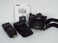 Photography - A Nikon D2H camera with flash