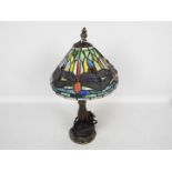 A small Tiffany style table lamp, the shade with dragonfly motif, approximately 37 cm (h).