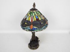 A small Tiffany style table lamp, the shade with dragonfly motif, approximately 37 cm (h).