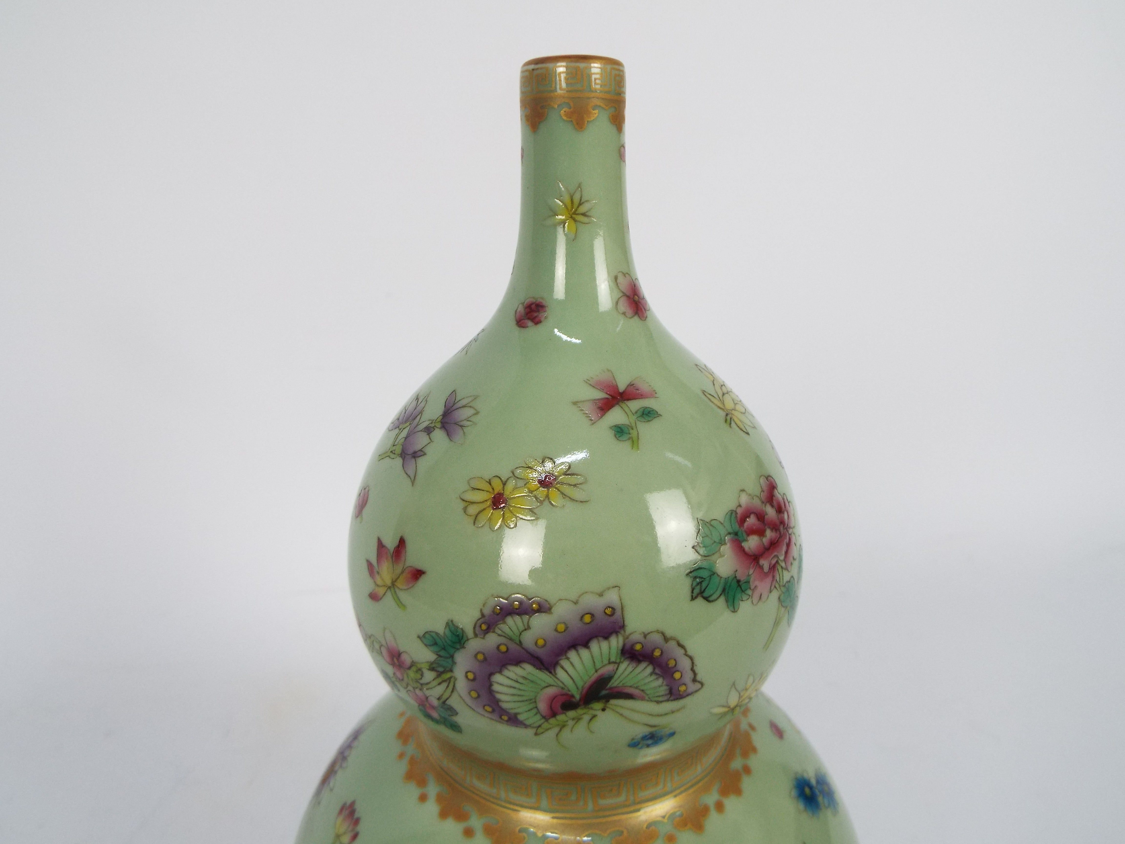 A Chinese double gourd vase decorated with flowers and butterflies against a green ground, - Image 16 of 18