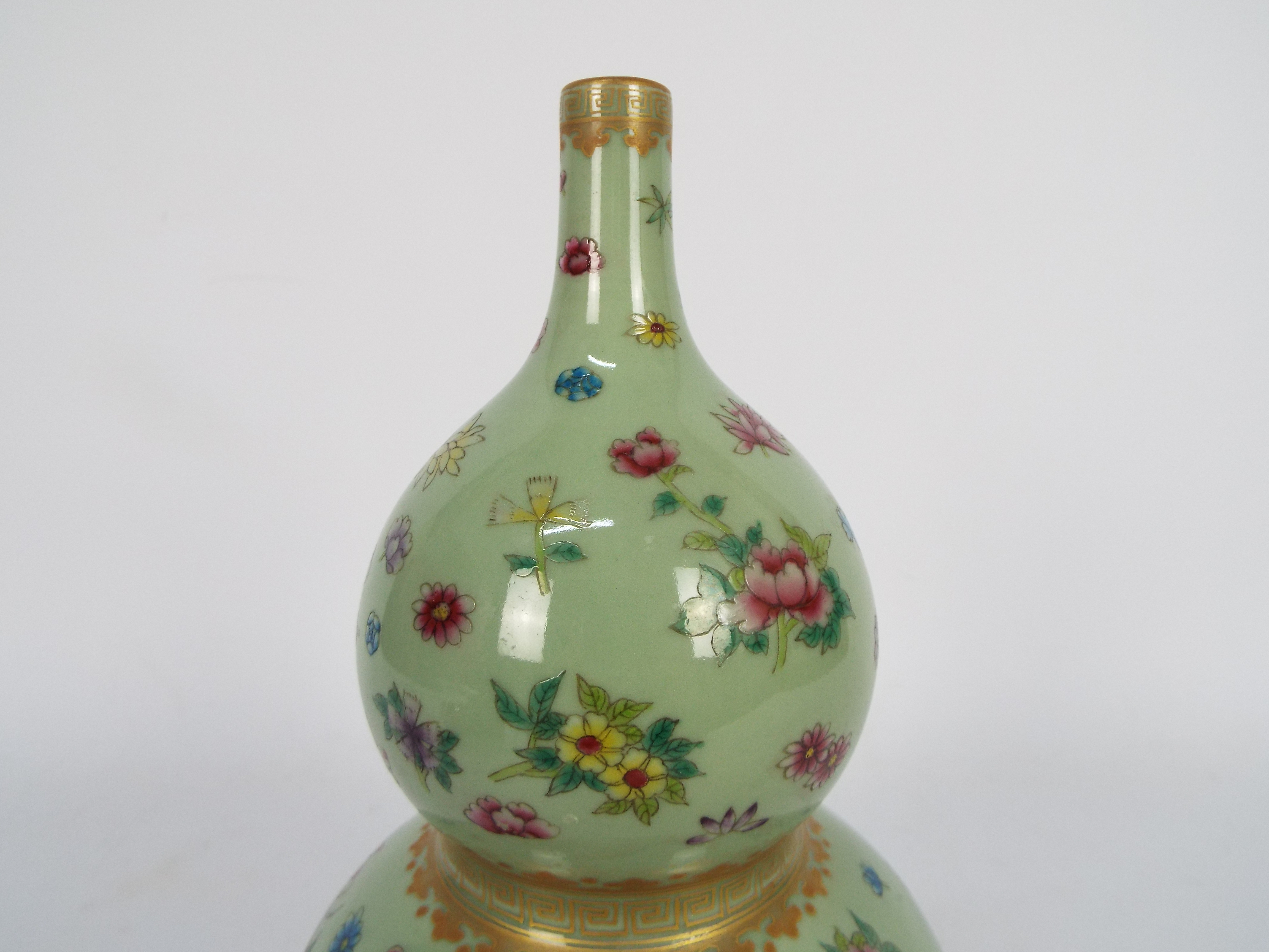 A Chinese double gourd vase decorated with flowers and butterflies against a green ground, - Image 13 of 18