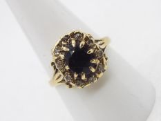 A 9ct gold sapphire and diamond cluster ring, size R, approximately 3.4 grams.