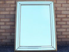 A wall mirror measuring approximately 105 cm x 80 cm.