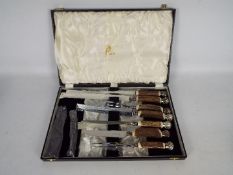 A Mappin & Webb seven piece carving set with white metal mounts and contained in fitted case.