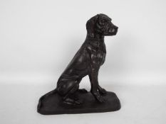 A bronzed metal model of a seated hound, approximately 22.5 cm (h).