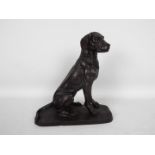 A bronzed metal model of a seated hound, approximately 22.5 cm (h).