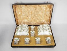 A silver and ceramic Aynsley six person tennis set comprising six cups with silver cup holders,