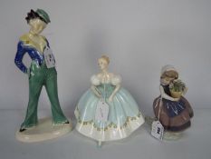 A Royal Doulton figurine First Dance HN2803, a Lladro figurine # 5223 Spring Is Here and one other,