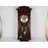 A mahogany cased wall clock, the case with carved decoration and astragal glazing,