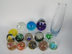 A quantity of paperweights and a glass vase.