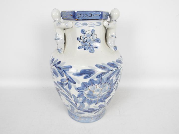 A large blue and white vase with floral decoration and applied figures of climbing boys, - Image 6 of 7