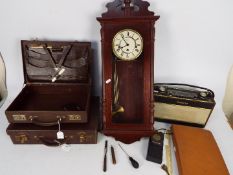 Two vintage brief cases, a Roberts radio, a Rapport mahogany cased wall clock and similar.