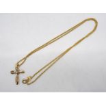 A 9ct gold, stone set, cross pendant on 9ct gold chain (clasp A/F), 44 cm (l), approximately 3.