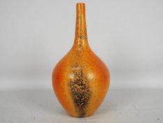 John Nuttgens - A 20th century bottle vase in a vibrant orange colour with black speckling,