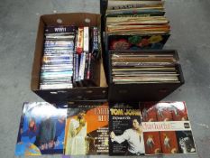 A collection of 12" vinyl records and a quantity of DVD's.