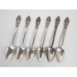 A set of six white metal coffee spoons with Buddha terminals, stamped Sterling Made In Siam,