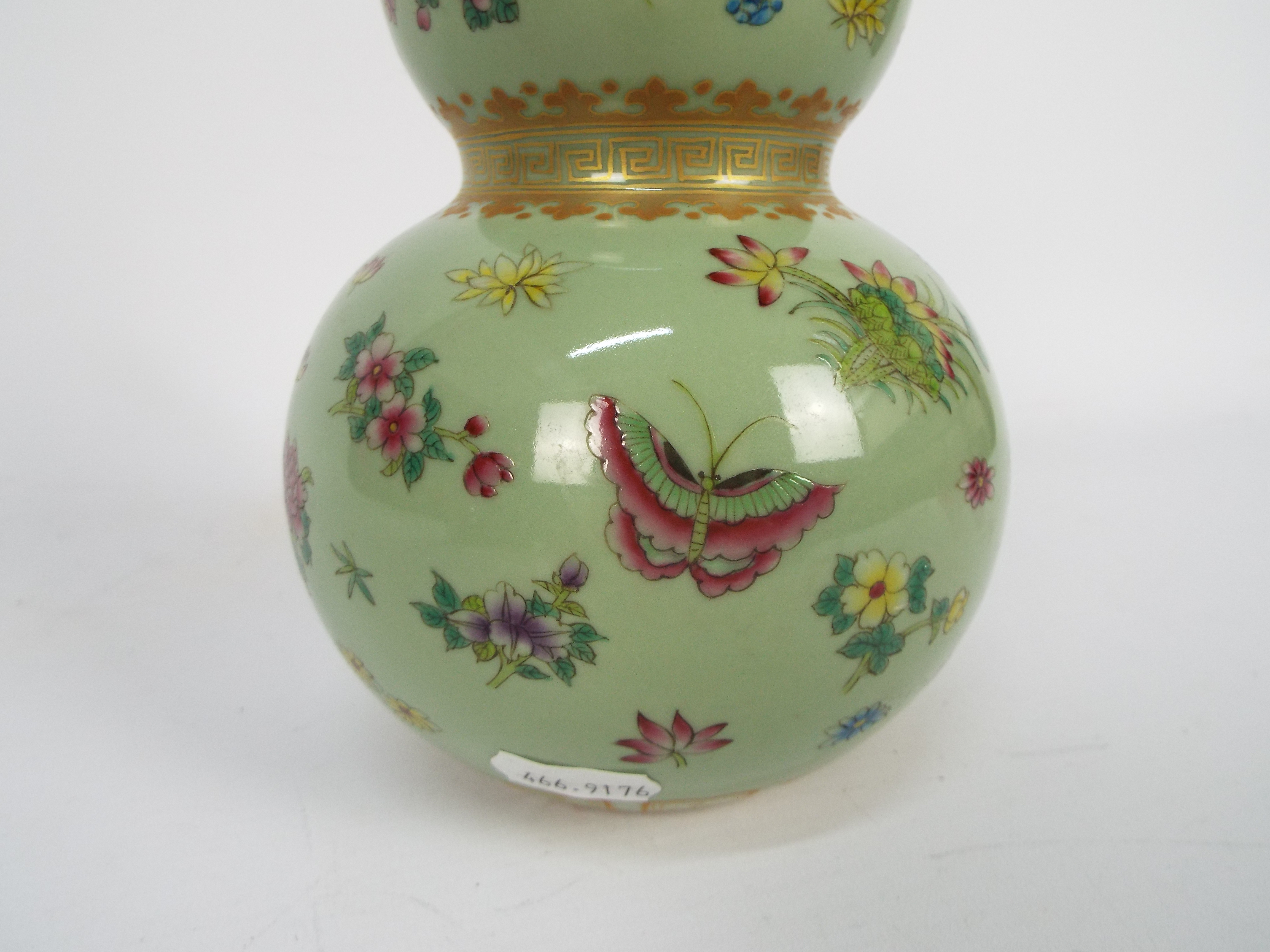 A Chinese double gourd vase decorated with flowers and butterflies against a green ground, - Image 15 of 18