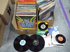 A quantity of 12" vinyl records to include The Bee Gees, ABBA, The Beatles, Motown, George Benson,