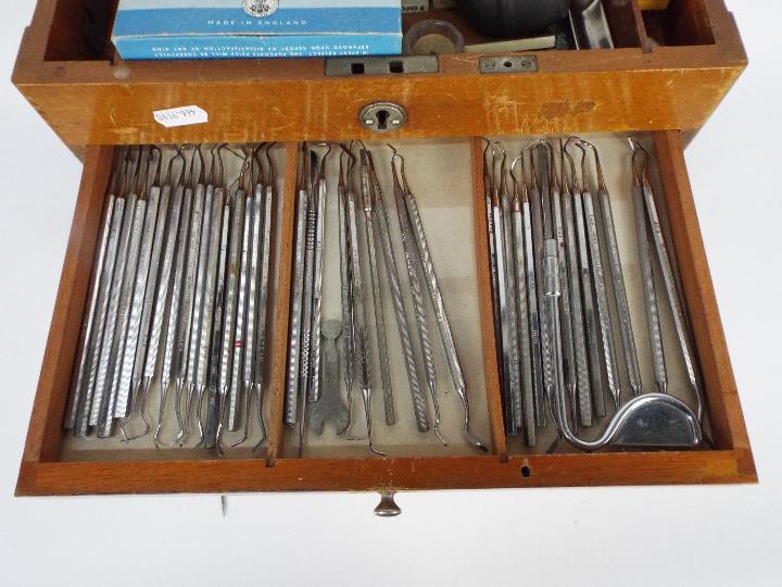 A dentists counter top or portable cabinet containing a quantity of dental tools and similar. - Image 8 of 9