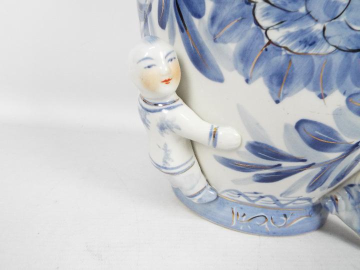 A large blue and white vase with floral decoration and applied figures of climbing boys, - Image 4 of 7