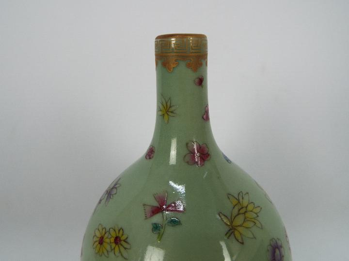 A Chinese double gourd vase decorated with flowers and butterflies against a green ground, - Image 11 of 18