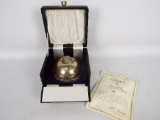 A limited edition silver trinket box of spherical form,