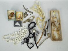 A small collection of costume jewellery and watches.