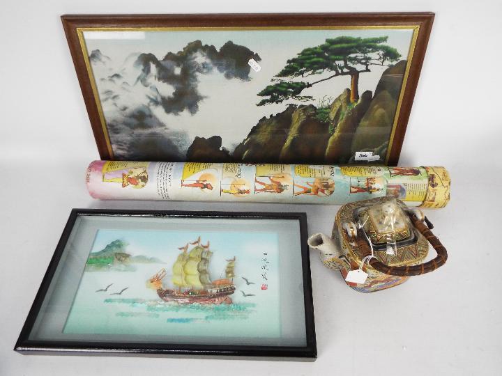 Two pieces of Japanese wall art and a teapot.