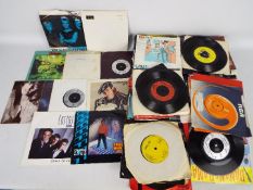 A quantity of 7" vinyl records to include The Police, Pet Shop Boys, Madness, Fleetwood Mac,