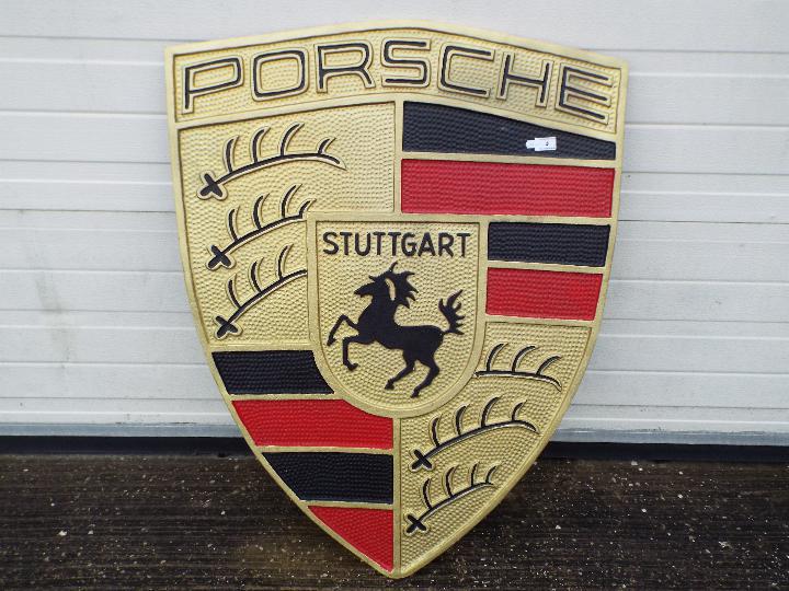 A large cast aluminium Porsche sign, approximately 96 cm x 72 cm.