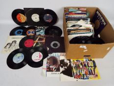 A collection of 7" vinyl records to include Queen, Pink Floyd, T-Rex, Blondie, George Harrison,