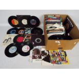 A collection of 7" vinyl records to include Queen, Pink Floyd, T-Rex, Blondie, George Harrison,