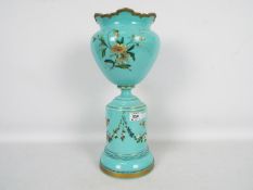 A Victorian glass pedestal vase with hand painted decoration of flowers and butterflies with gilt