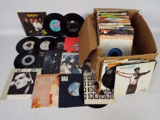 A quantity of 7" vinyl records to include Queen, T-Rex, Duran Duran, Michael Jackson, Madness,
