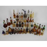 A collection of vintage miniatures to include whisky, rum, port, liquors and similar.