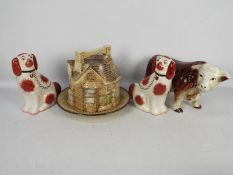 Lot to include a cheese dome in the form of houses, fireside dogs and a model of a bull.