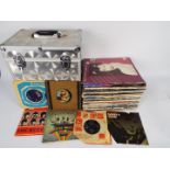 A carry case of vinyl records, predominantly 12", to include The Beatles, Fleetwood Mac,