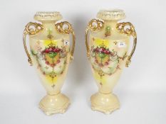 A large pair of twin handled vases with floral and gilt decoration, approximately 49 cm (h).