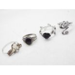 Four silver and white metal rings, sizes from P to Z.