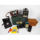 Lot to include cameras, vintage tin, boxed American Exchange wrist watch and other.
