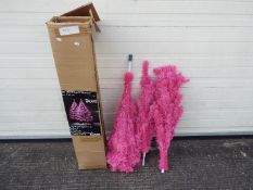 An unlit 6 foot pink Christmas tree. Please note the picture is an example of the tree decorated.