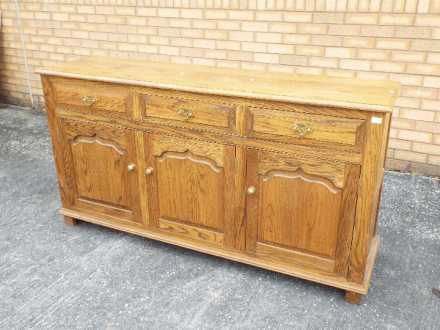 A sideboard with three short drawers over three enclosed cupboards, - Image 2 of 2