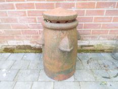 An unusual terracotta clay vented chimney pot with 'Ventop' cowl flue ventilator,