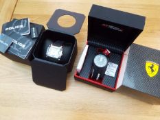 Two designer watches - Ferrari Pit Crew black watch with white batons in presentation case with