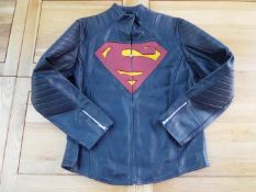 A black faux leather zip front jacket with Superman motif to the front, size L,